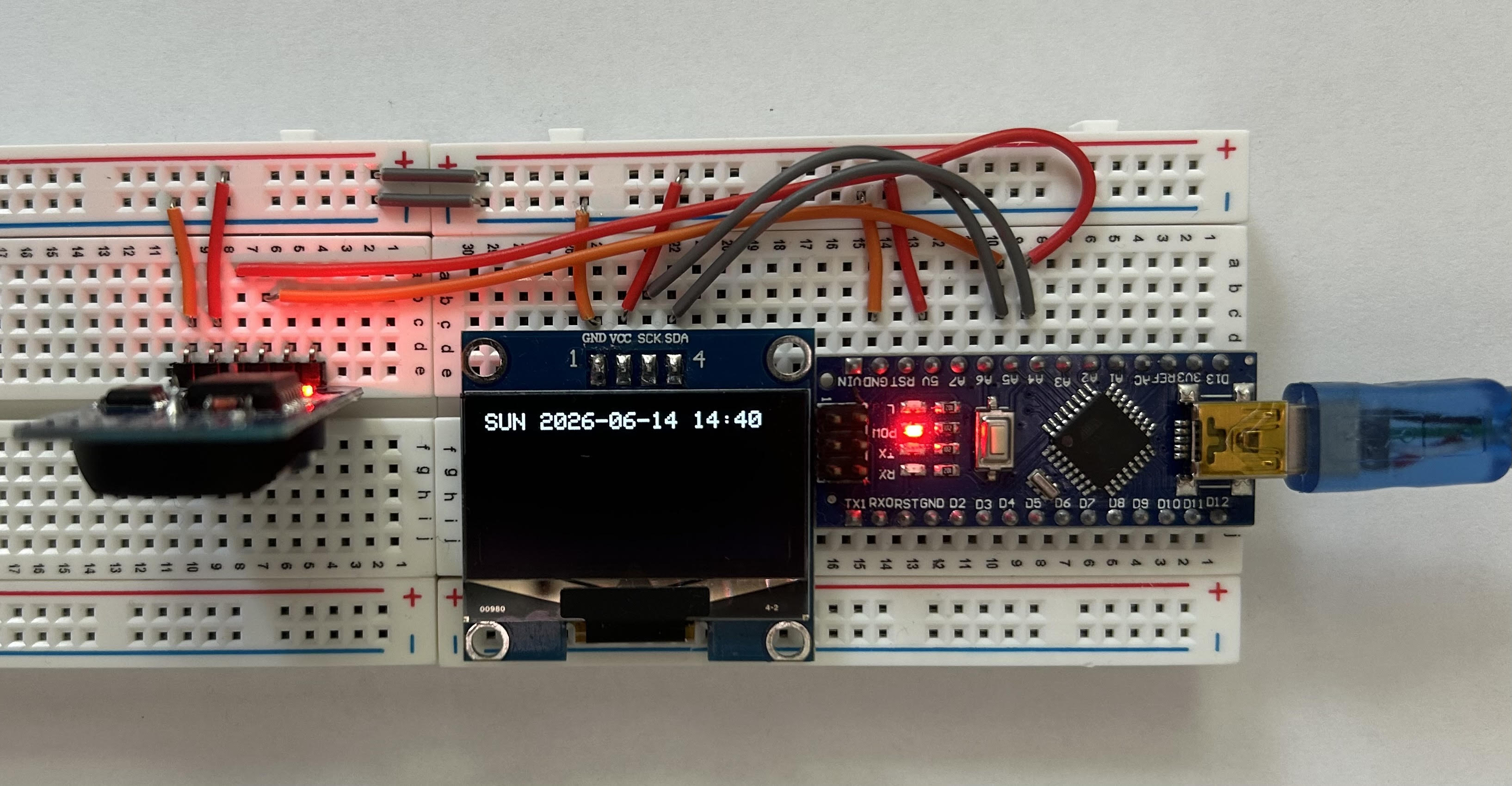 Demonstration of the clock displaying time on the OLED screen.